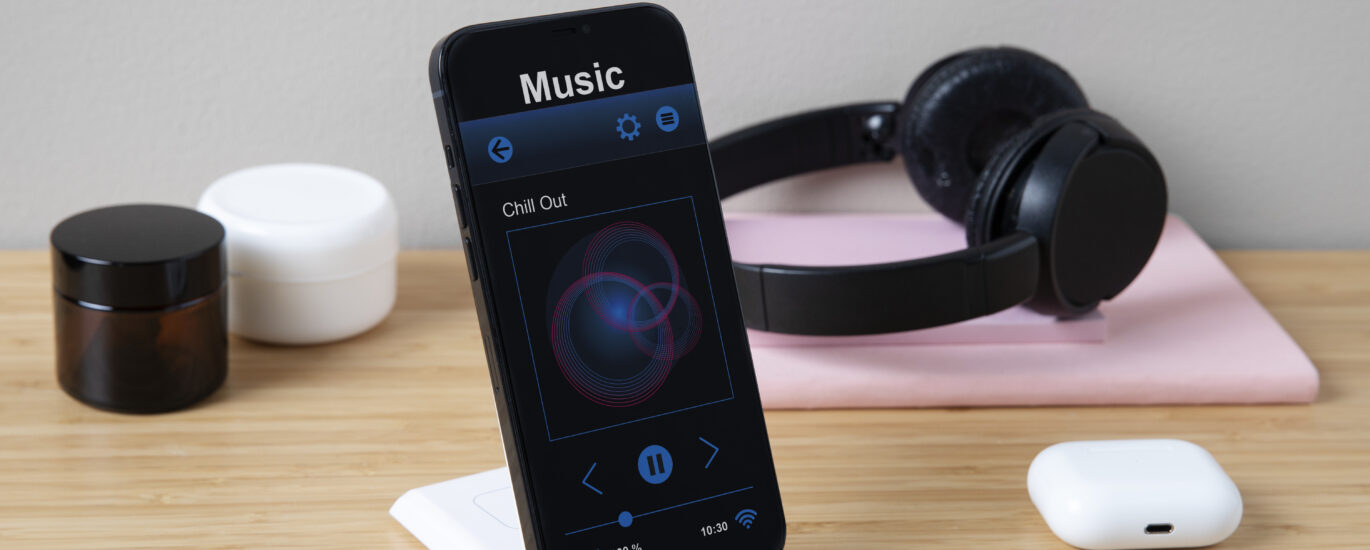Illustration showing an iPhone screen displaying AirPods battery levels using the pop-up window and Batteries widget.