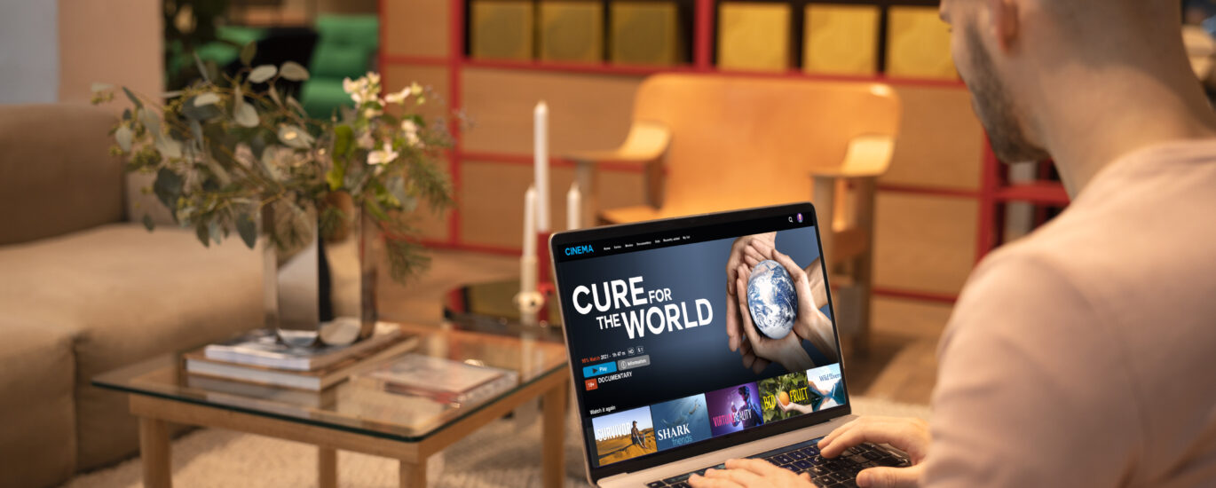 “Laptop connected to a TV screen showing media content, demonstrating how to connect my laptop to my TV using HDMI or wireless casting.”