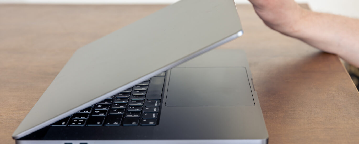 “Bending laptop screen showing frame misalignment and repair process with tools”