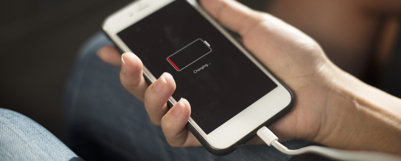 “Smartphone plugged in but charging slowly, showing slow battery increase and user checking cable for why is my phone charging so slow.”