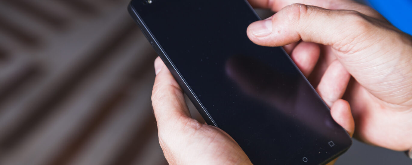 Close-up of a Samsung Galaxy S24 showing the screen and side buttons, demonstrating how to turn off Samsung S24 using the power menu.