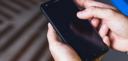 Close-up of a Samsung Galaxy S24 showing the screen and side buttons, demonstrating how to turn off Samsung S24 using the power menu.