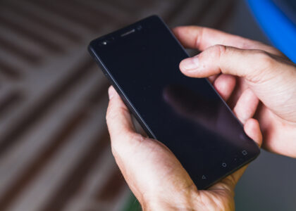 Close-up of a Samsung Galaxy S24 showing the screen and side buttons, demonstrating how to turn off Samsung S24 using the power menu.